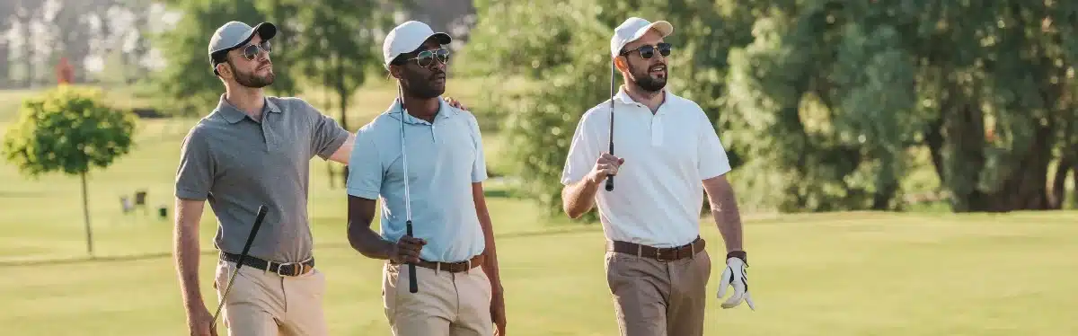 3 men walking on golf course